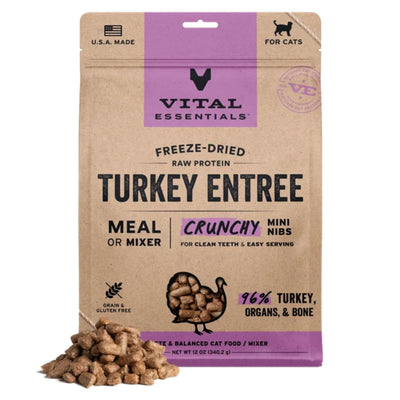 Brown and purple bag of Vital Essentials freeze-dried turkey cat food with a pile of mini nibs in front.