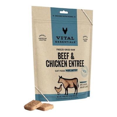 Kraft paper pouch of Vital Essentials freeze-dried raw beef and chicken cat food, with two brown patties in front.