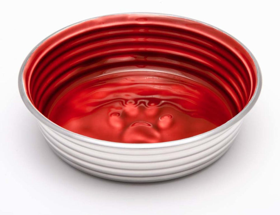 Ribbed steel dog bowl with glossy red interior and embossed paw print