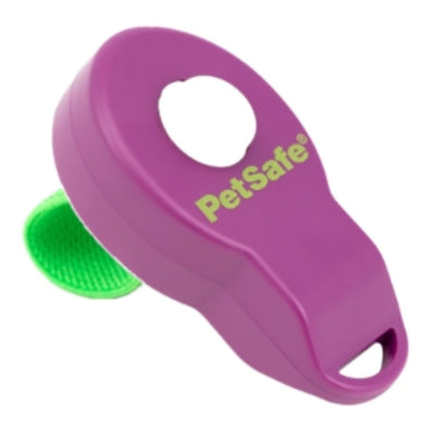 Purple PetSafe dog clicker with a green button, shown at an angle against a white background.