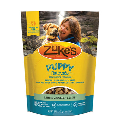 Zuke's Puppy Naturals dog treats in a yellow pouch with a woman and puppy on the front.