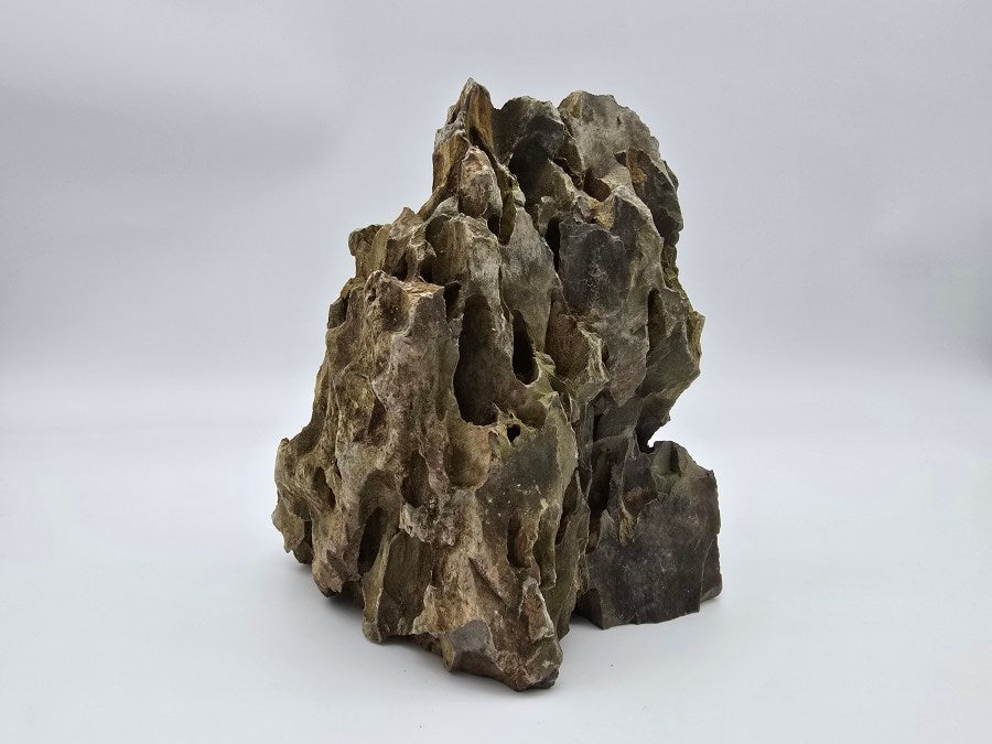 Dragon Stone Peaks rock formation with deep crevices, shown on white background